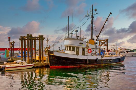 An old fishing trawler docked at a pier