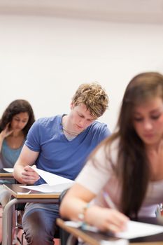 Portrait of young students doing an assignment in a classroom