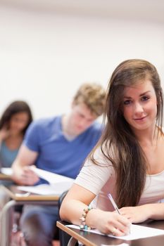 Portrait of students doing an assignment in a classroom