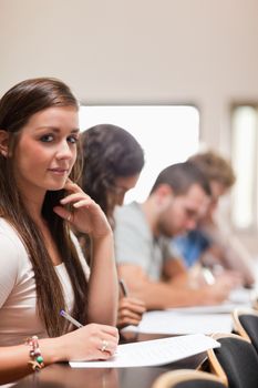 Portrait of good looking students listening a lecturer in an amphitheater