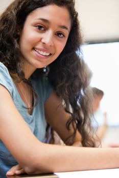 Portrait of a smiling young student in a classroom