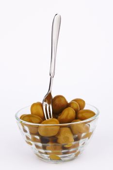 Green olives in bowl  on white