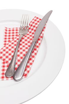 knife and fork on a napkin on the white 