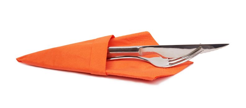 knife and fork on a napkin on the white 
