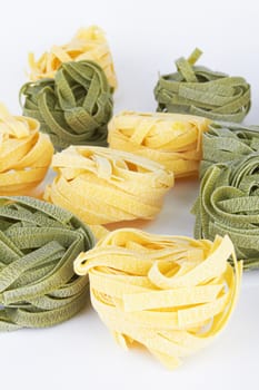Italian pasta tagliatelle on white