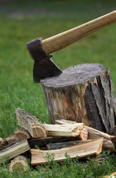 Wooden logs and rusty axe