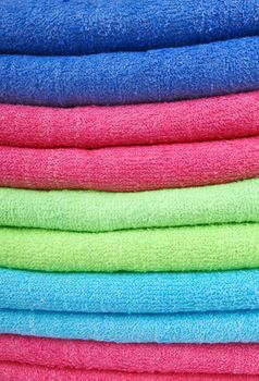 stacked colorful towels on a white background