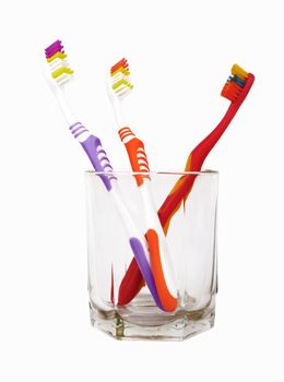 Toothbrushes in glass isolated on white 