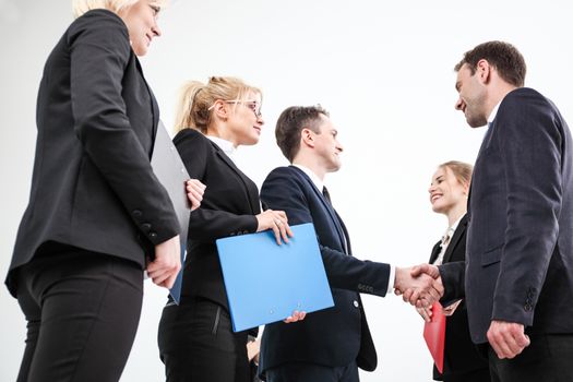 Business people shaking hands, finishing up a meeting, white background