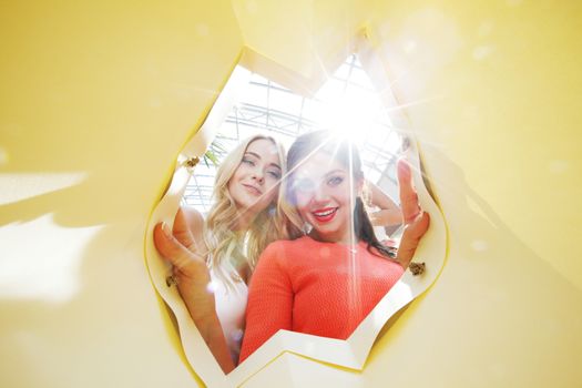 beautiful young women looking inside bag