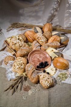 Different kinds of bread and pastry on a canvas studio background