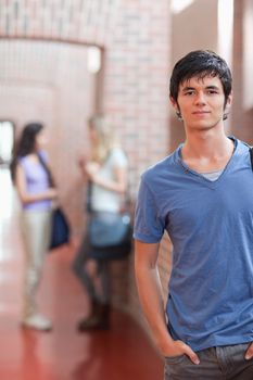 Portrait of a handsome student posing in a corridor