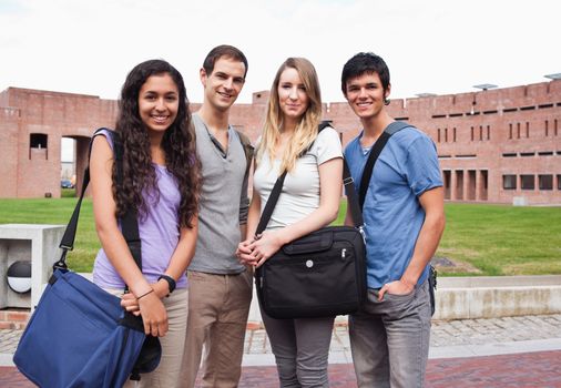 Fellow students posing outside a building