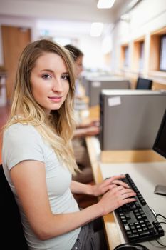 Portrait of a student working with a computer in an IT room