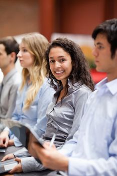 Portrait of a businesswoman smiling at the camera during a presentation