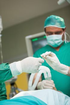 Surgeons holding a scalpel in a surgical room