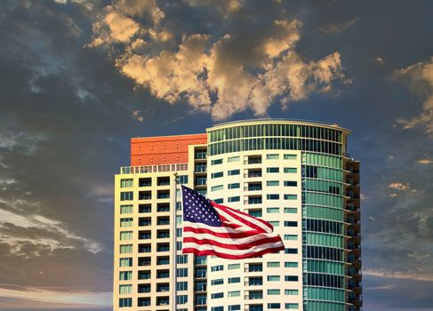 A nice new high rise condominium and an American Flag