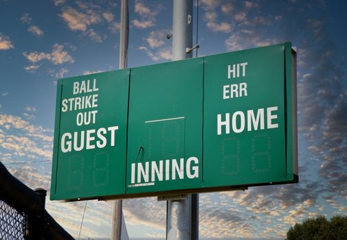 A new green and white scoreboard in a baseball park