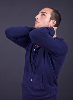 young casual man close up portrait on a dark background