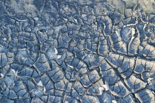 cracked soil textured background. Cracks on the dried soil in drought season