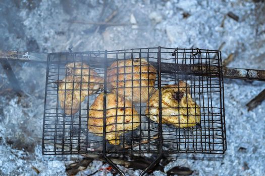 Barbeque from pork prepared outdoors on a hot summer day in a camp