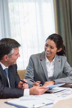 Business people happily talking during meeting