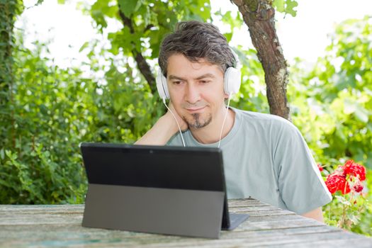 casual man working with a tablet pc, outdoor