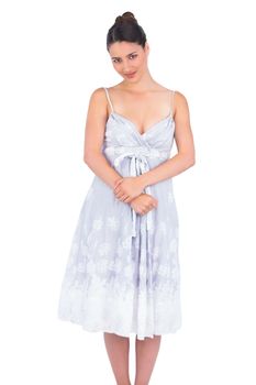 Peaceful seductive young model in summer dress posing on white background