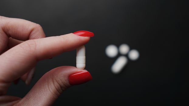 Woman holding pill, capsule in doctor hand close-up. Concept of medication, drug testing. Epidemic and virus concept