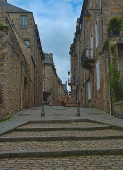 DINAN, FRANCE - April 7th 2019 - Empty street with stone building in traditional town