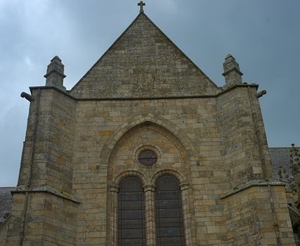 Top of old medieval stone catholic church in Dinan, France