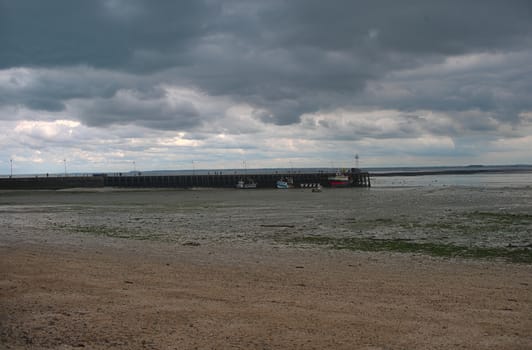 Atlantic ocean shore with pier for shipping boats at Cancale, France