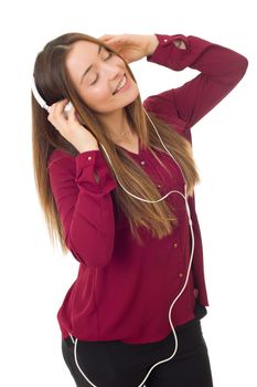 Beautiful young woman listen music with headphones, isolated on white