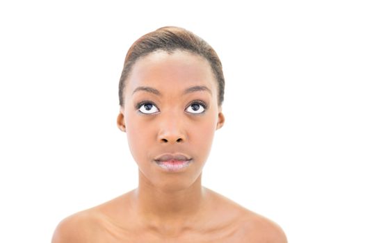 Portrait of natural nude beauty looking up on white background