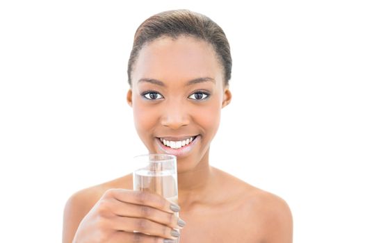 Smiling natural beauty holding water glass on white background