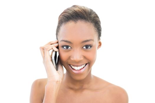 Smiling natural beauty phoning on white background