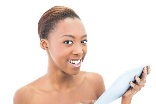 Cheerful natural beauty holding tablet computer on white background