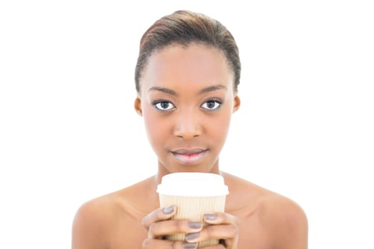 Serious natural beauty holding coffee cup on white background