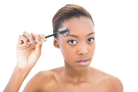 Natural beauty using eyebrow brush on white background