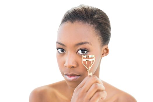 Natural beauty using eye lash curler on white background