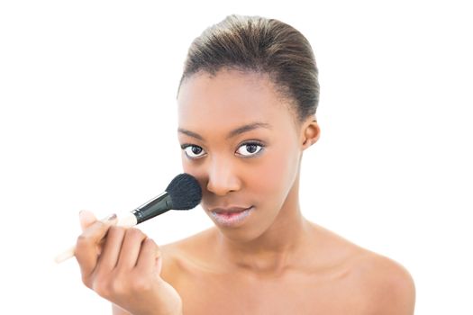 Natural beauty applying makeup on white background