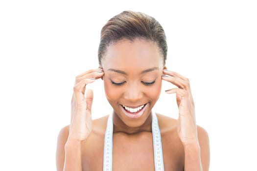 Cheerful natural beauty with measuring tape over the neck on white background