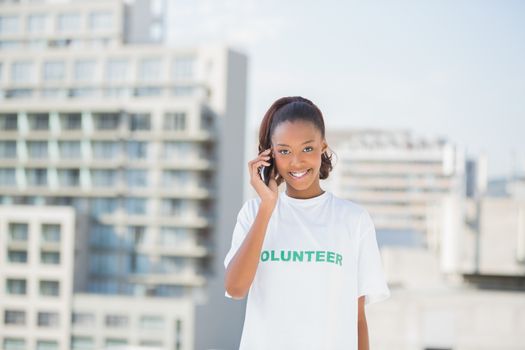 Cheerful altruist woman on the phone outdoors on urban background