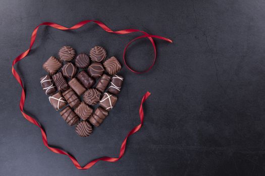 Chocolate pralines  for Valentines day or Mothers day concept on black background