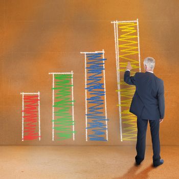 Rear view of mature businessman pointing at graphic on brown wall