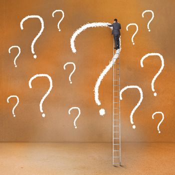 Rear view of businessman standing on ladder touching question mark 