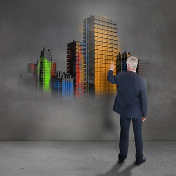 Rear view of mature businessman looking at grey wall showing colorful city