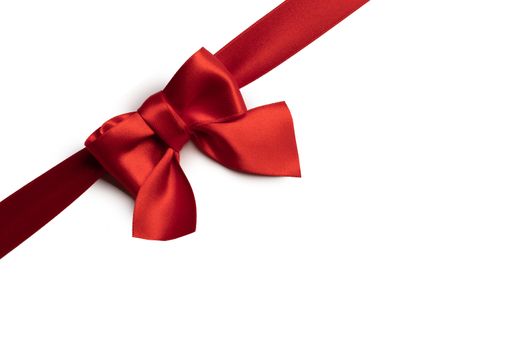 Red satin ribbon bow isolated on white background