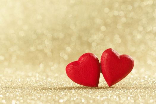 Two red wooden hearts symbol of love on background with beautiful bokeh, Saint Valentine Day celebration, copy space for text