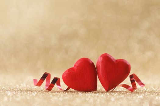 Two red wooden hearts symbol of love on background with beautiful bokeh, Saint Valentine Day celebration, copy space for text